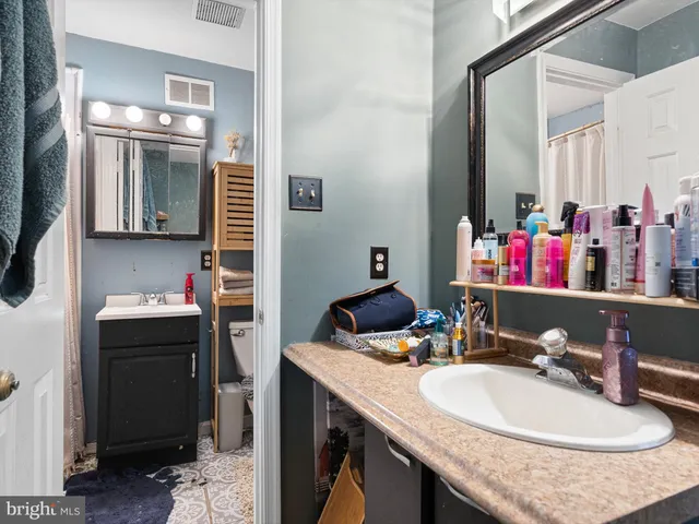 a bathroom with a sink double vanity and a mirror