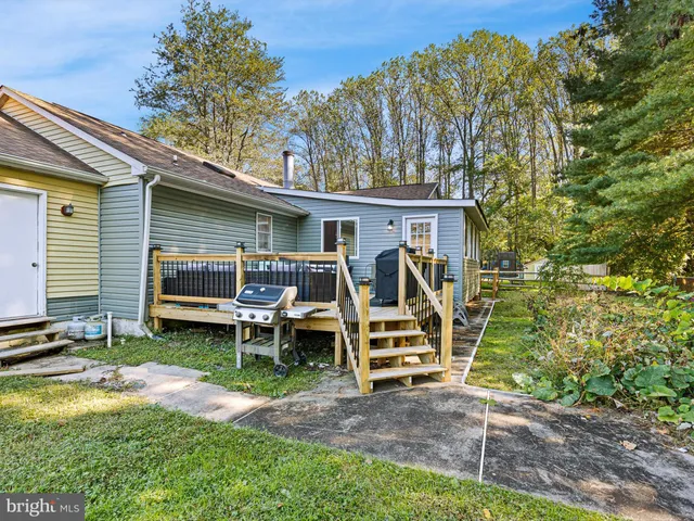 a view of a chair and tables in backyard of the house