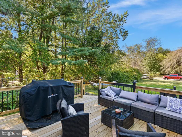 a view of a patio with couches under an umbrella