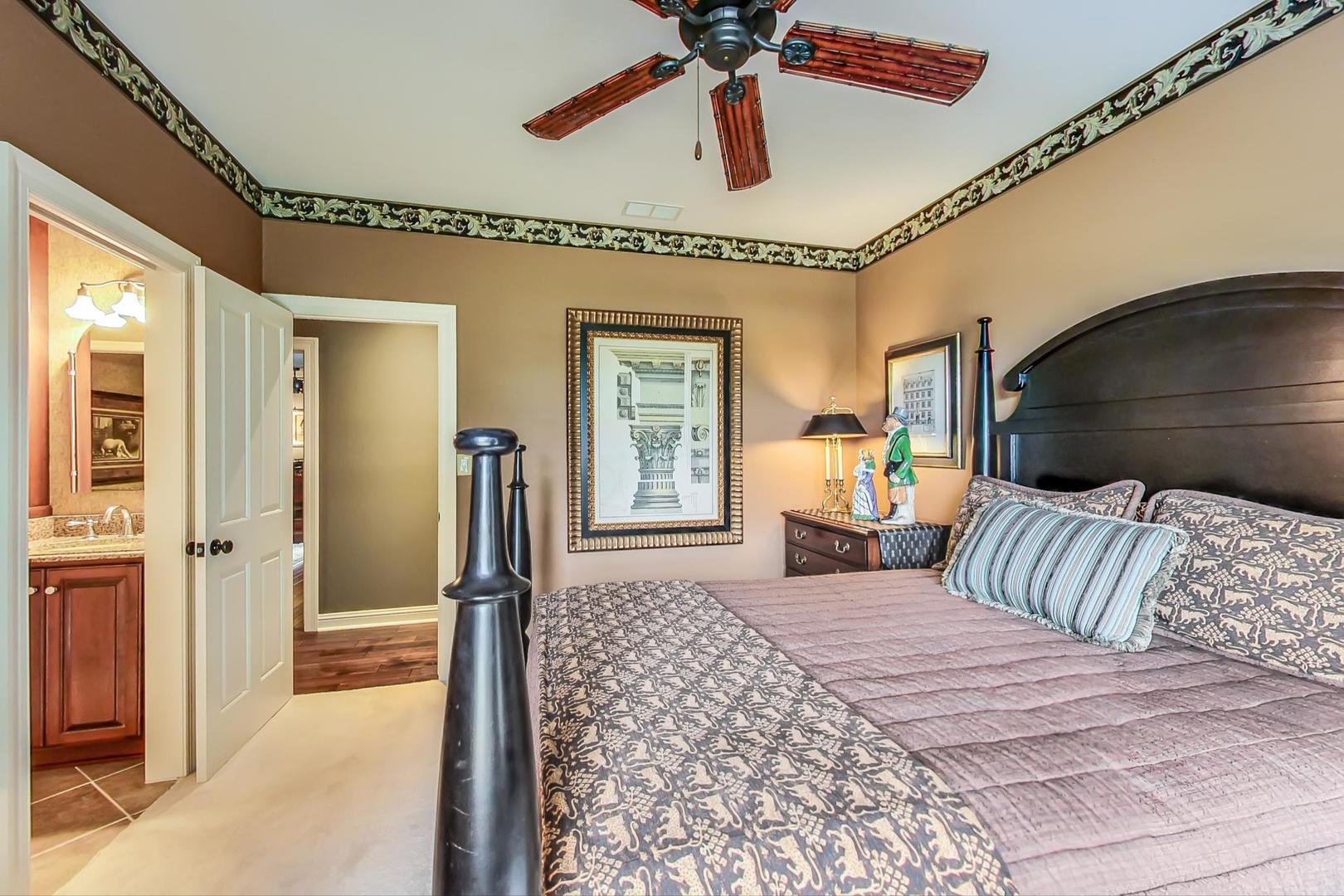 5N198 Dover Hill Road St. Charles, IL 60175 - Photo 45 of 65 a bedroom with a large bed and a chandelier
