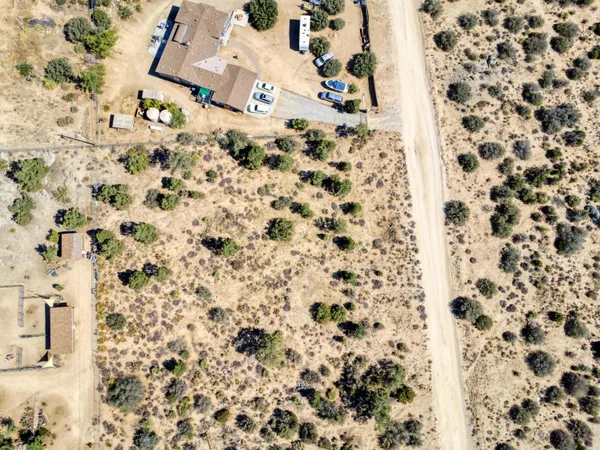 an aerial view of residential house and sandy dunes