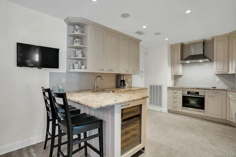 a kitchen with granite countertop a sink stove and cabinets