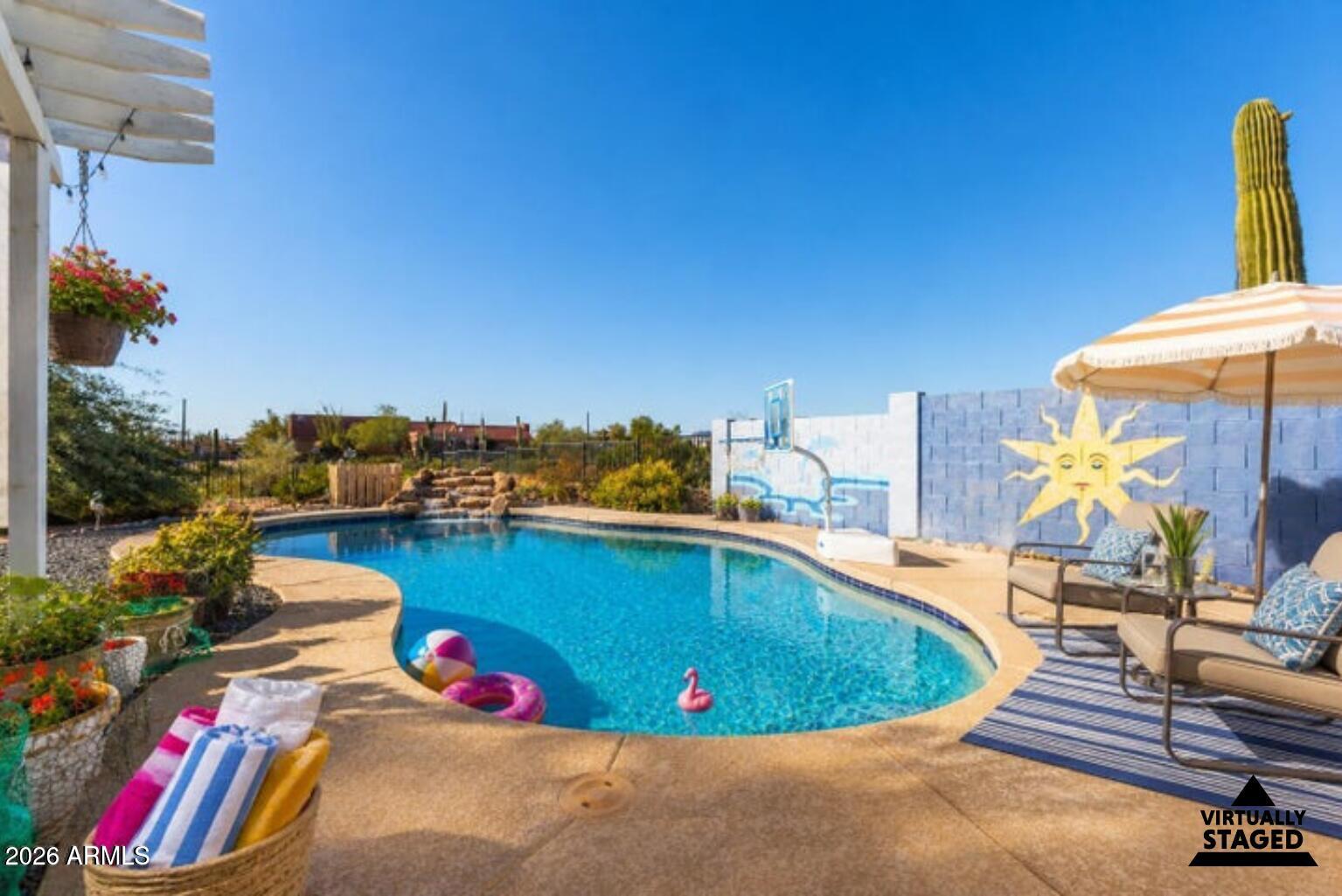 614 North Tomahawk Road Apache Junction, AZ 85119 - Photo 1 of 44 a view of a swimming pool with a lounge chair