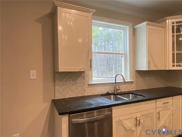 a kitchen with granite countertop a sink and a window