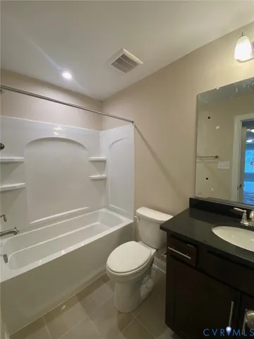a bathroom with a granite countertop sink toilet a mirror and shower
