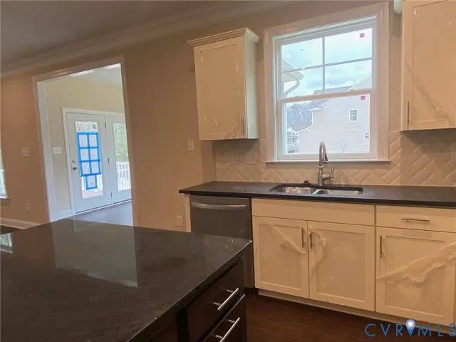 a kitchen with granite countertop white cabinets and a granite counter tops
