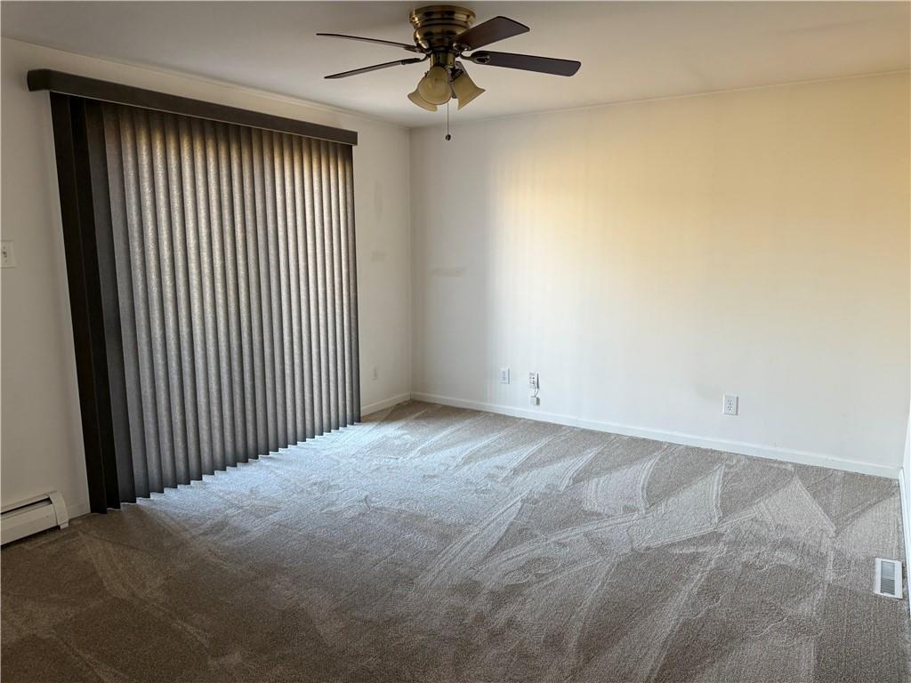 243 South Sycamore Street Mount Pleasant, PA 15666 - Photo 11 of 27 a view of a livingroom with a ceiling fan and window