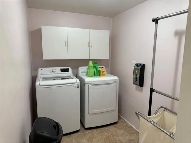 a bathroom with a granite countertop toilet sink and mirror