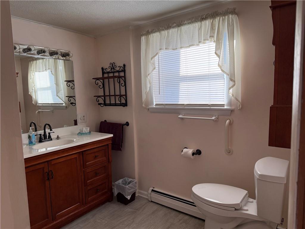 243 South Sycamore Street Mount Pleasant, PA 15666 - Photo 13 of 27 a bathroom with a granite countertop toilet sink and mirror