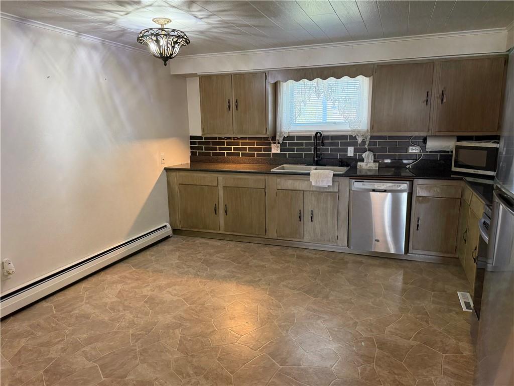 243 South Sycamore Street Mount Pleasant, PA 15666 - Photo 7 of 27 a kitchen with a refrigerator and a stove
