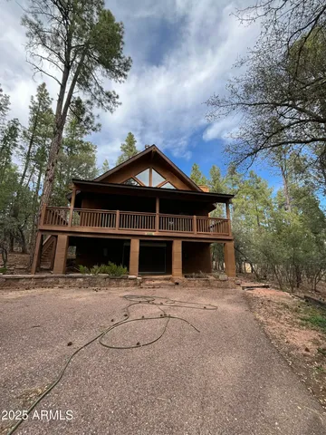 a view of a house with large trees