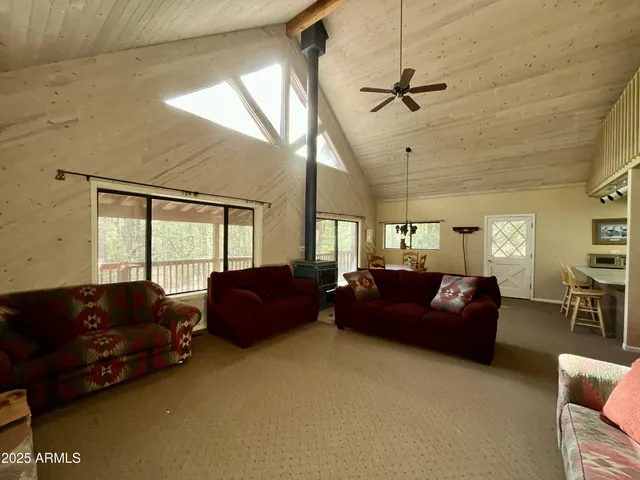 a living room with couches dresser and a couch with wooden floor