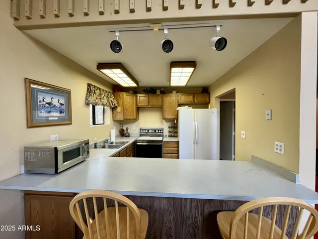 a kitchen with kitchen island a stove and a refrigerator