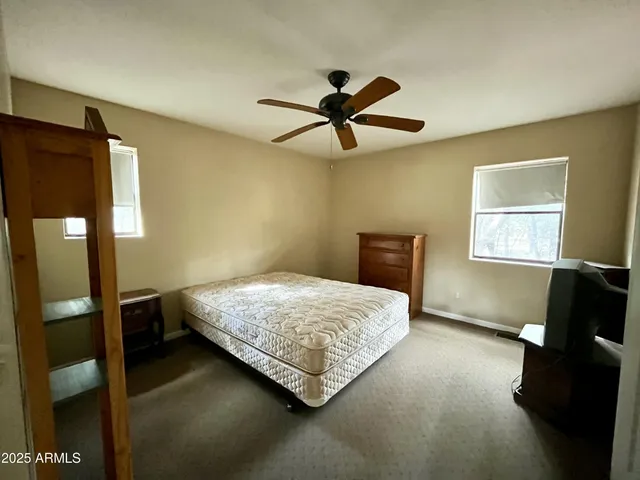 a bedroom with a bed and window