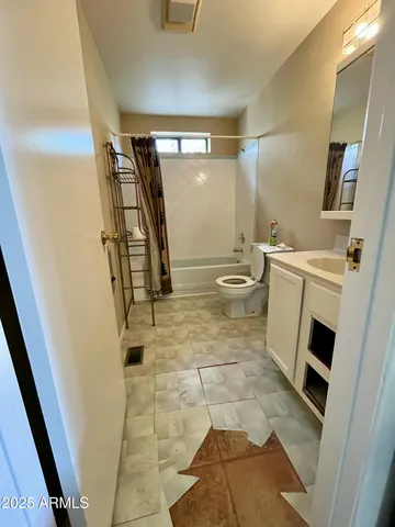a bathroom with a sink a toilet a mirror and shower