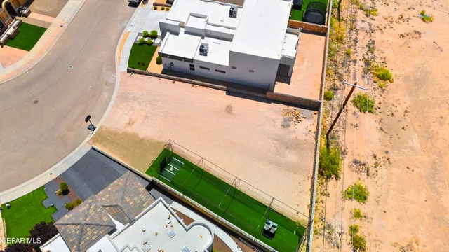 an aerial view of a residential building and car parked