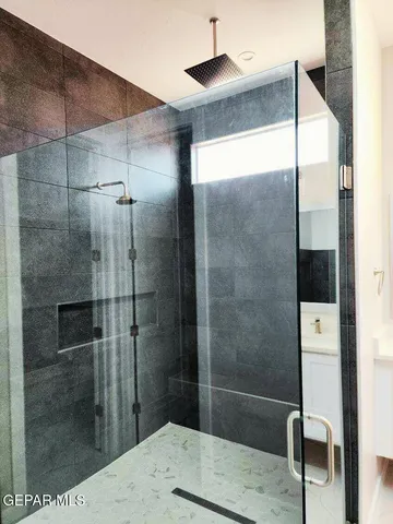 a bathroom with a shower and a sink