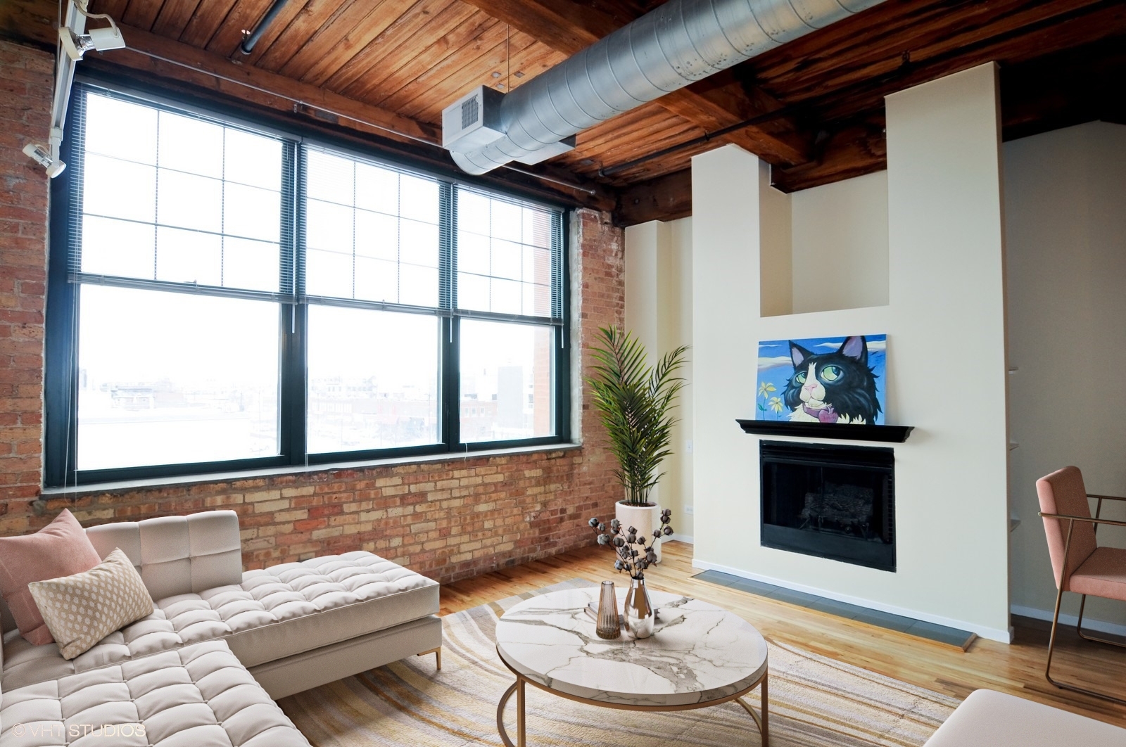 1000 West Washington Boulevard, Unit 348 Chicago, IL 60607 - Photo 4 of 9 a living room with furniture and a fireplace