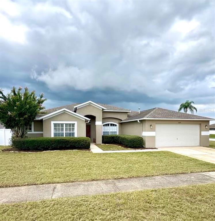 4347 Brandon Ridge Drive Valrico, FL 33594 - Photo 12 of 13 a front view of a house with a garden and lake view