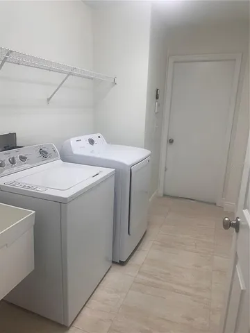 a utility room with dryer and washer