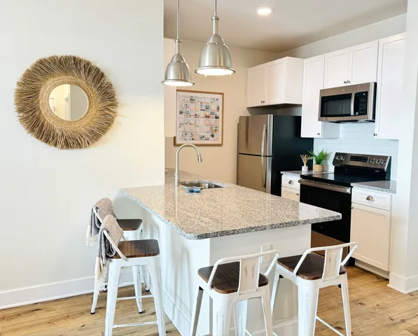 a kitchen with stainless steel appliances granite countertop a stove refrigerator sink and cabinets