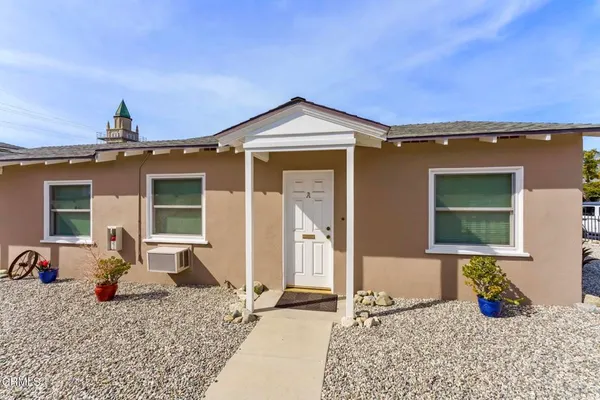 a front view of a house with backyard