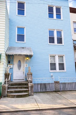 a view of a kitchen with furniture and an empty room