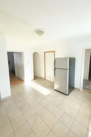 a kitchen with granite countertop a sink and white cabinets