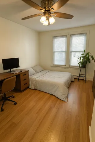 a bedroom with a bed and a potted plant