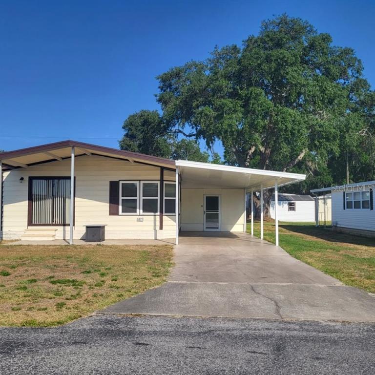 a front view of a house with a garden and yard
