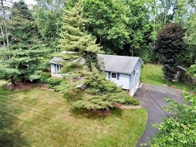 an aerial view of a house with a yard