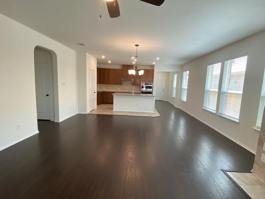 17110 Gibbons Path Round Rock, TX 78664 - Photo 2 of 12 a view of a living room with kitchen countertops and wooden floor