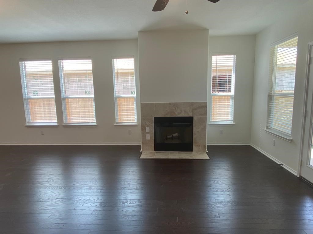 17110 Gibbons Path Round Rock, TX 78664 - Photo 4 of 12 an empty room with wooden floor and windows