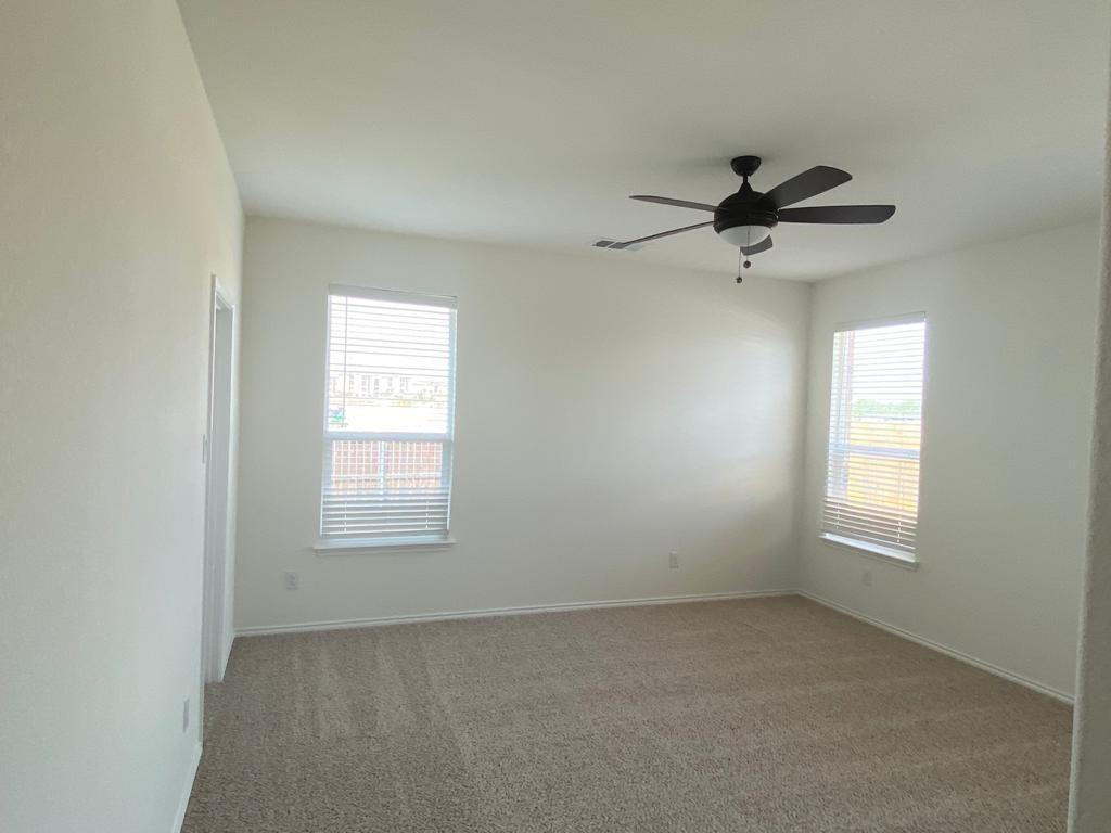 17110 Gibbons Path Round Rock, TX 78664 - Photo 5 of 12 an empty room with windows and fan