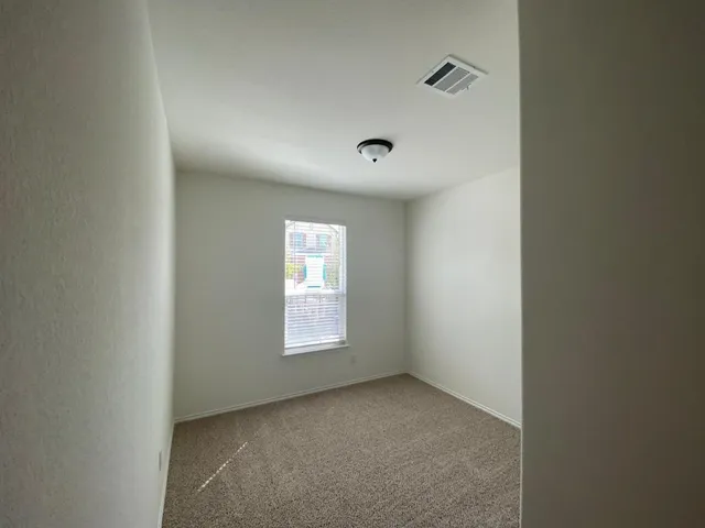 a view of an empty room and a window