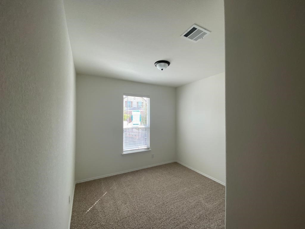 17110 Gibbons Path Round Rock, TX 78664 - Photo 7 of 12 a view of an empty room and a window