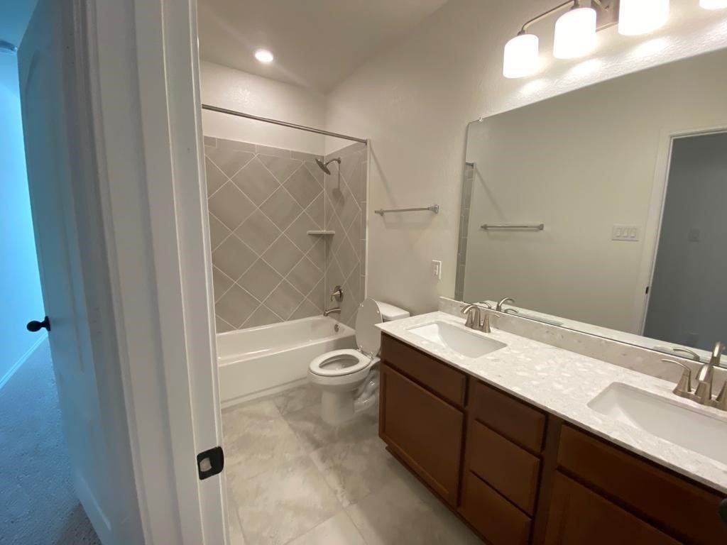 17110 Gibbons Path Round Rock, TX 78664 - Photo 9 of 12 a bathroom with a sink a toilet and shower