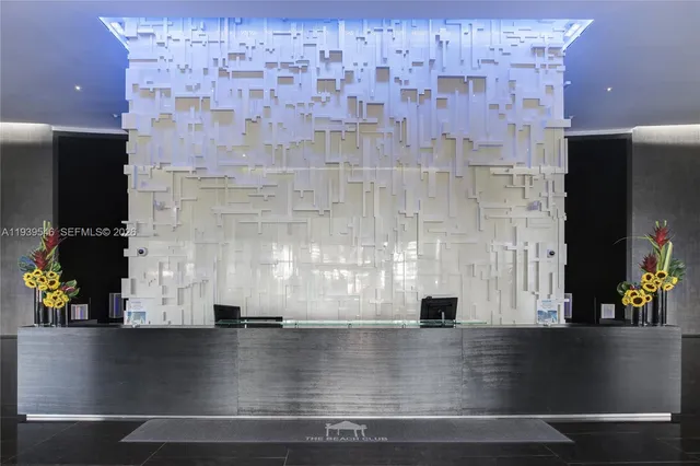 a living room with couches and kitchen view with wooden floor