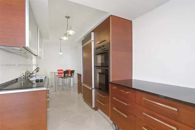 a kitchen with a refrigerator and a sink