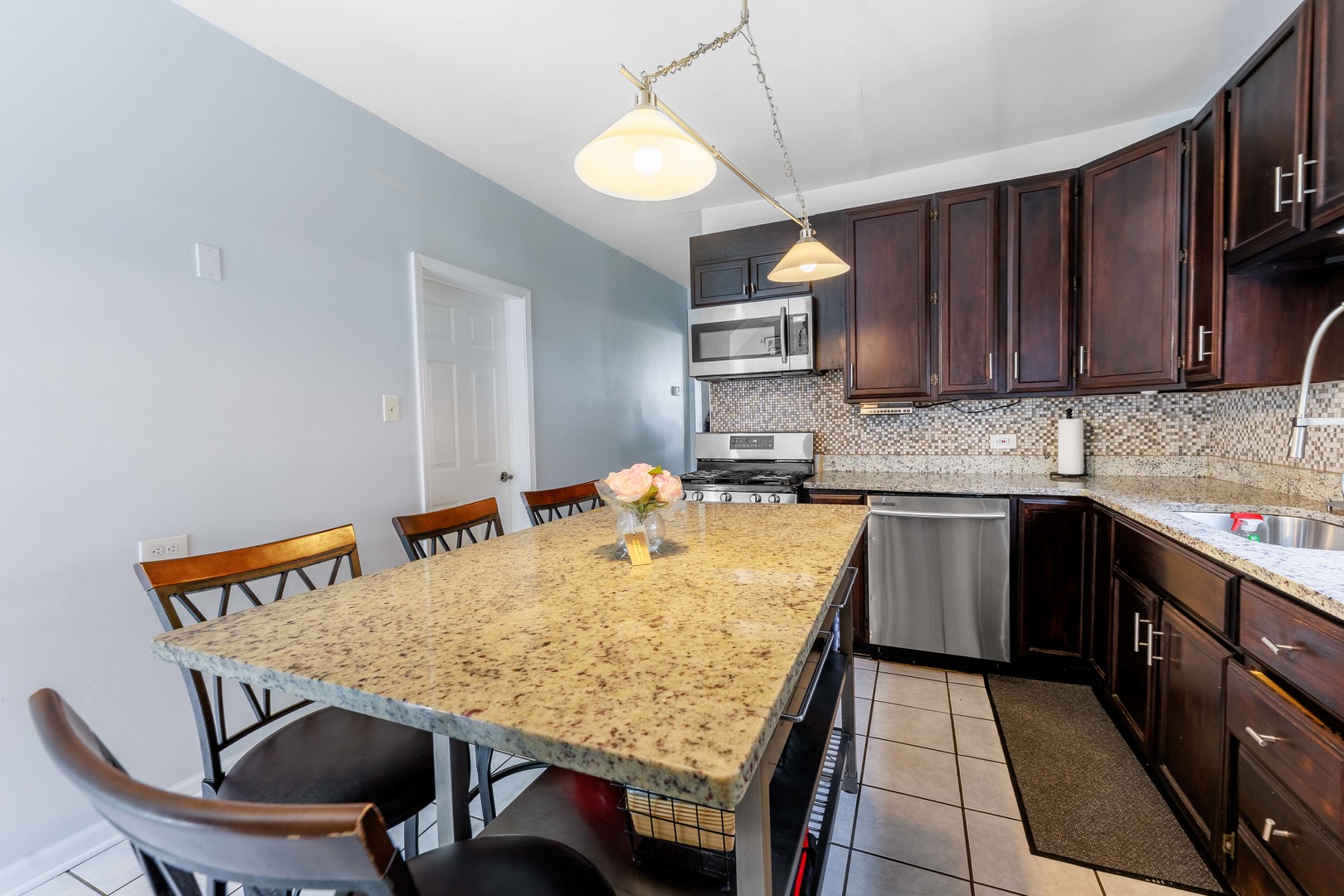 5935 West Patterson Avenue Chicago, IL 60634 - Photo 11 of 34 a kitchen with a table chairs sink and cabinets
