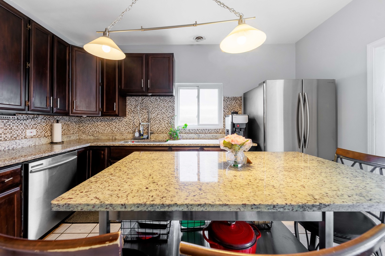5935 West Patterson Avenue Chicago, IL 60634 - Photo 12 of 34 a kitchen with kitchen island granite countertop wooden cabinets a sink and dishwasher