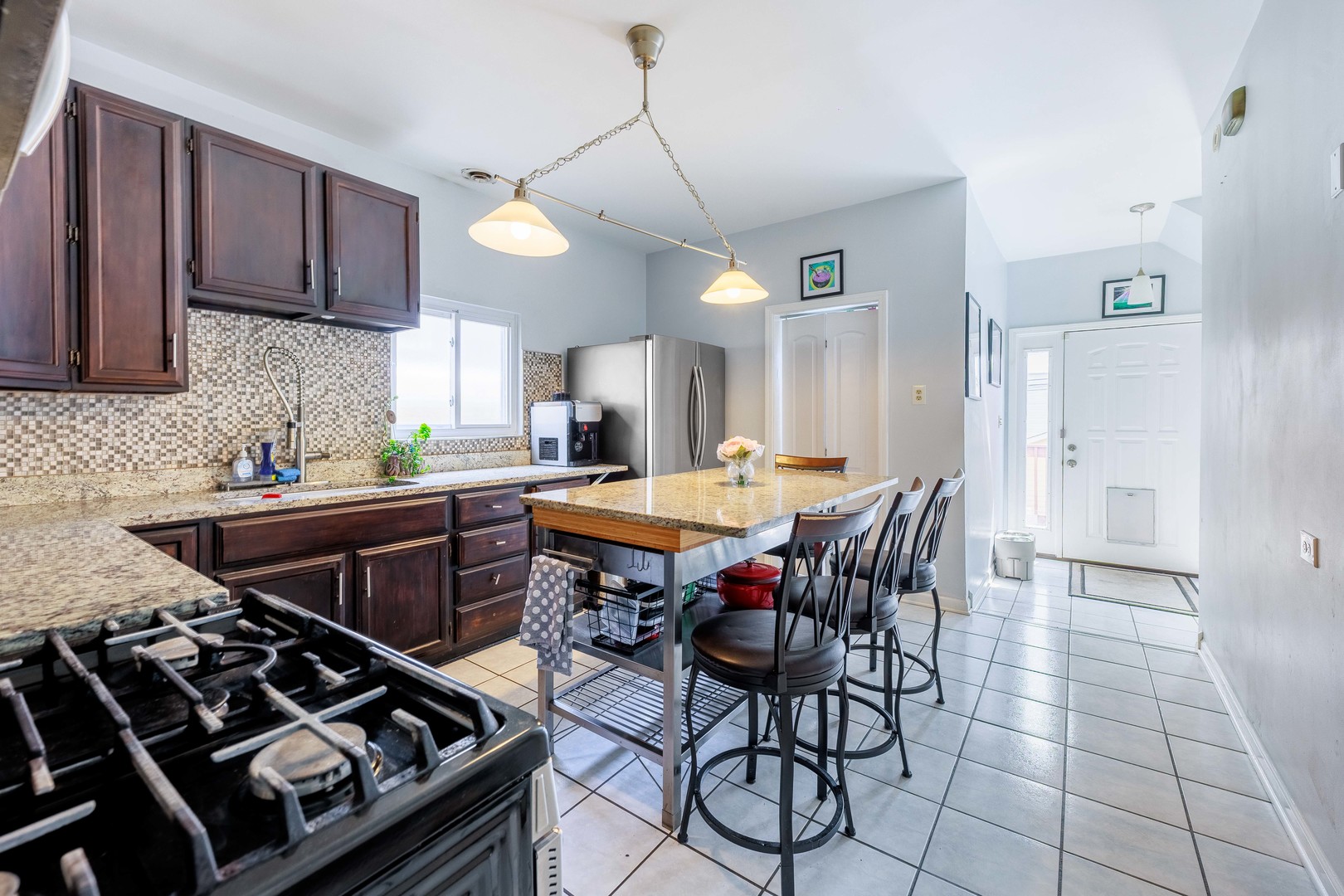 5935 West Patterson Avenue Chicago, IL 60634 - Photo 13 of 34 a kitchen with stainless steel appliances a stove a sink dishwasher and a refrigerator with wooden cabinets