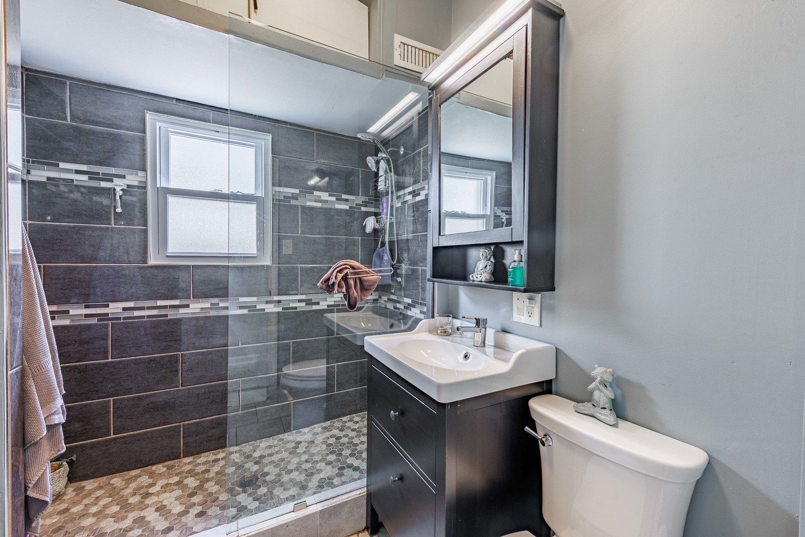 5935 West Patterson Avenue Chicago, IL 60634 - Photo 16 of 34 a bathroom with a sink toilet and shower