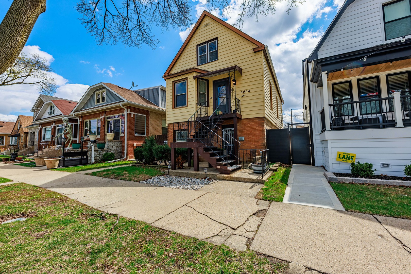 5935 West Patterson Avenue Chicago, IL 60634 - Photo 2 of 34 a front view of a house with a yard and potted plants