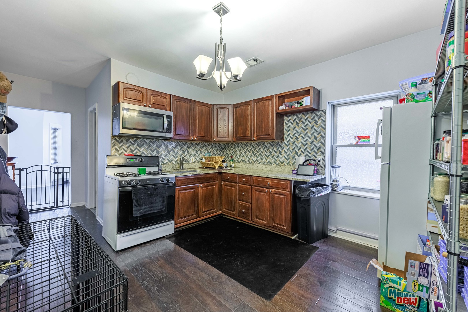5935 West Patterson Avenue Chicago, IL 60634 - Photo 29 of 34 a kitchen with stainless steel appliances granite countertop a refrigerator and a stove top oven