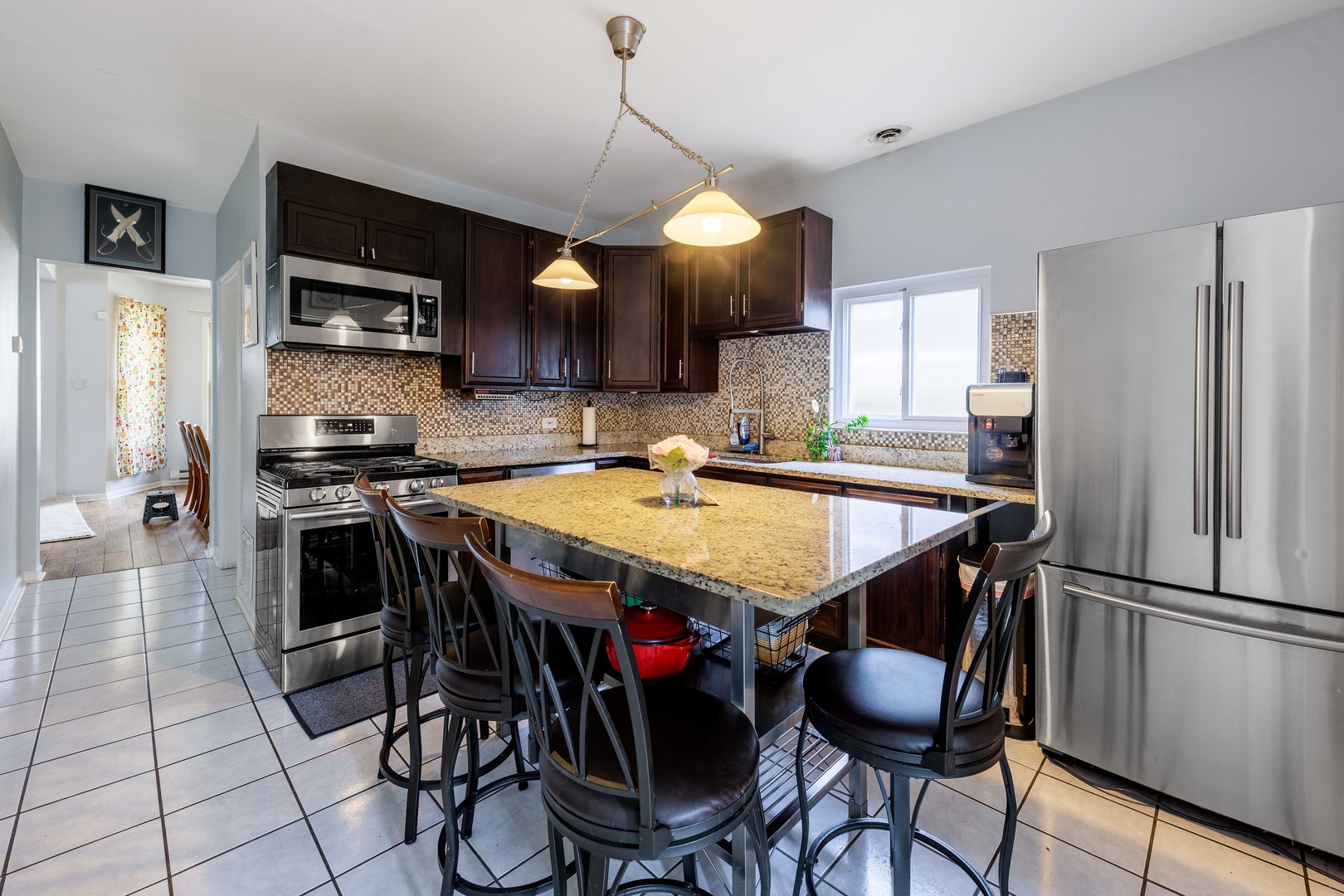 5935 West Patterson Avenue Chicago, IL 60634 - Photo 10 of 34 a kitchen with stainless steel appliances granite countertop a sink a stove and a refrigerator