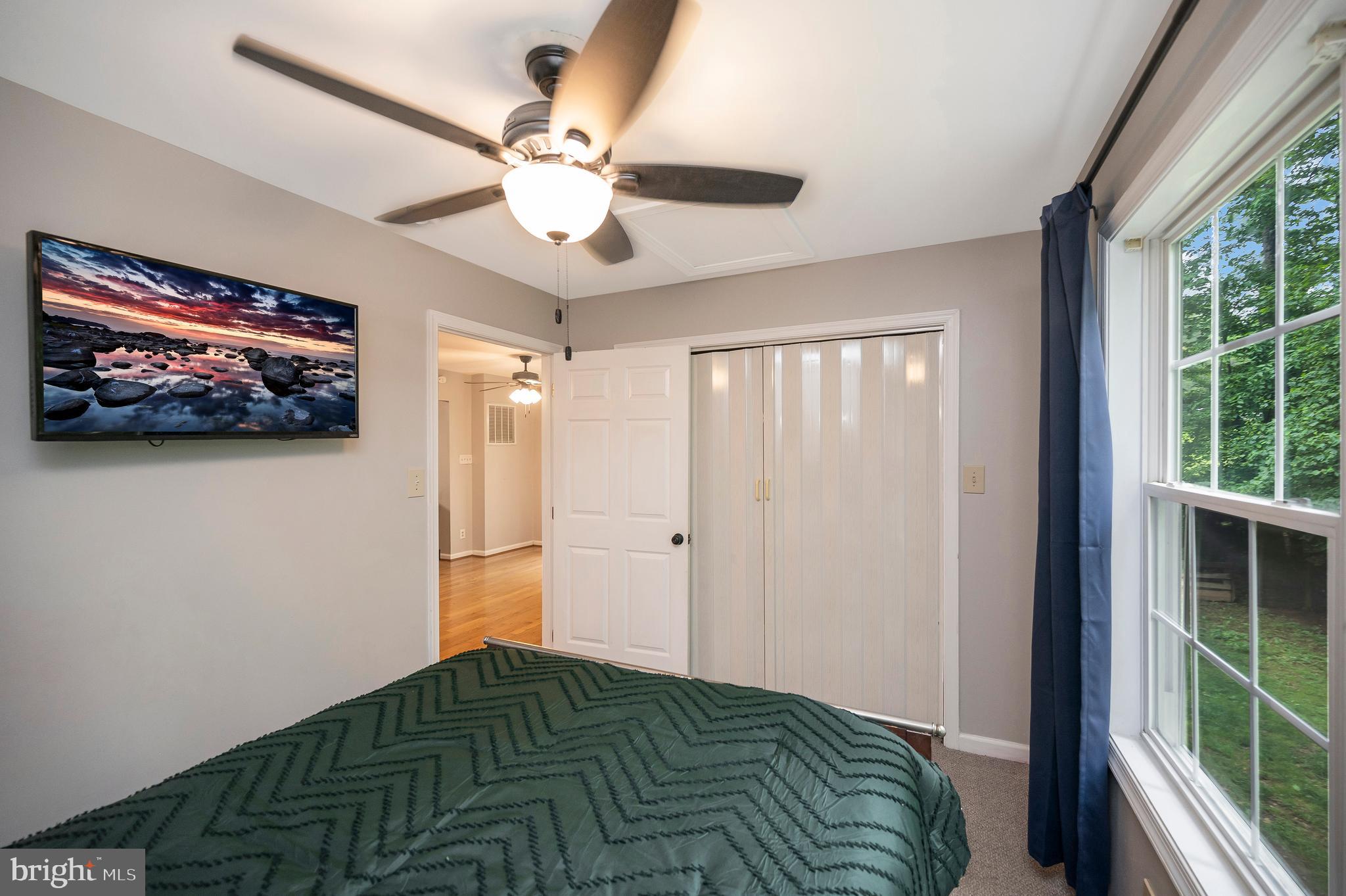 679 Cropp Road Fredericksburg, VA 22406 - Photo 30 of 39 a bedroom with a bed and a chandelier