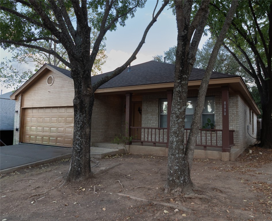 a view of a house with a tree in the yard