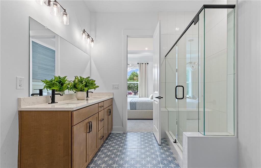 299 Rockledge Bend Powder Springs, GA 30127 - Photo 11 of 12 a bathroom with a sink a mirror and a shower