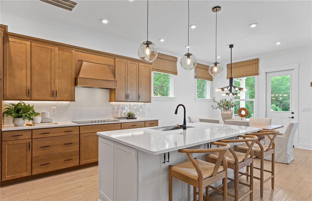 299 Rockledge Bend Powder Springs, GA 30127 - Photo 7 of 12 a kitchen with a sink a center island a stove and a cabinets